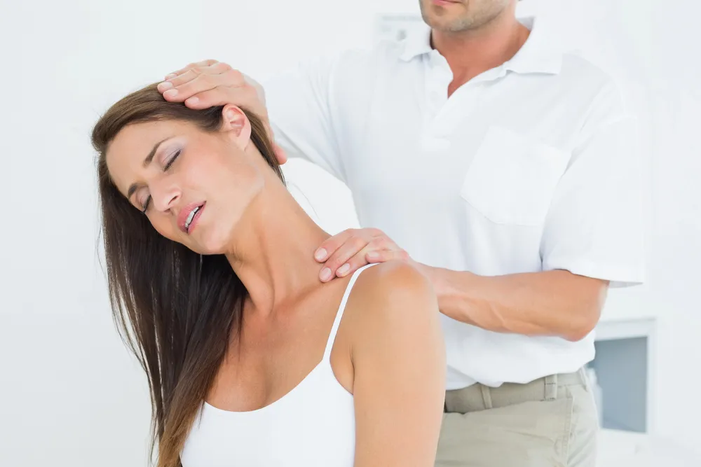 Therapist working with a patient on neck mobility